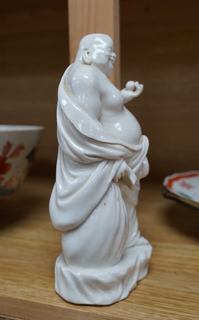 A Chinese blanc de chine figure of Budai, 18cm high. Condition - fair to good